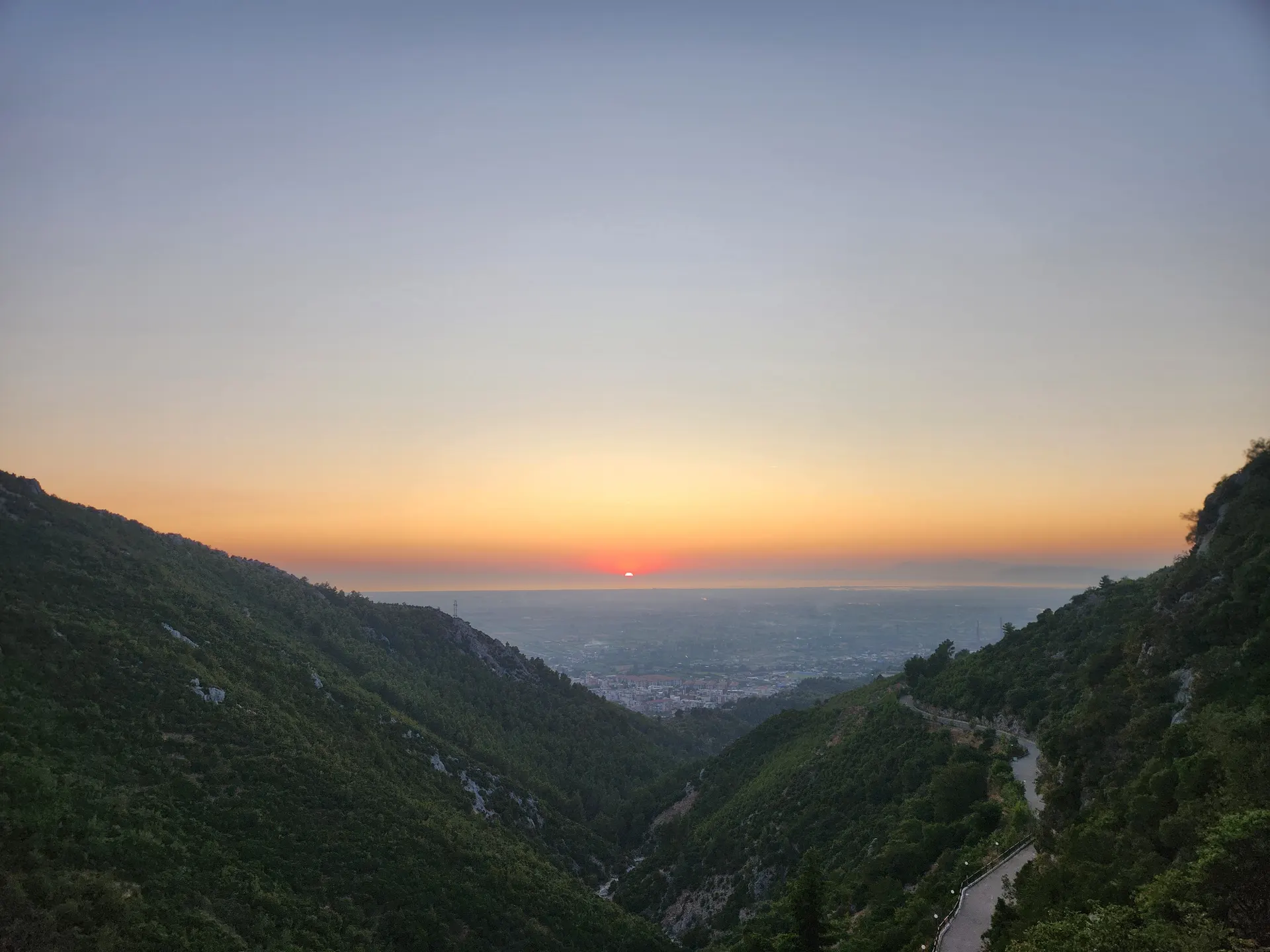 Sunset over a misty mountain valley in the Albanian Alps
